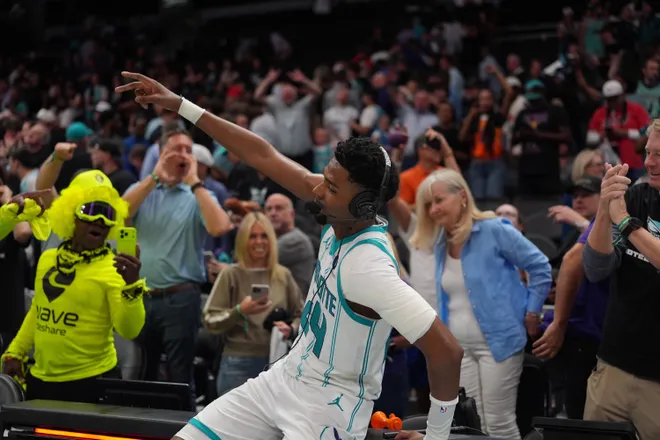 Apr 14, 2026; Charlotte, North Carolina, USA; Charlotte Hornets forward Brandon Miller (24) and fans react to the overtime win during the play-in rounds between the Charlotte Hornets and the Miami Heat of the 2026 NBA Playoffs at Spectrum Center. Mandatory Credit: Jim Dedmon-Imagn Images