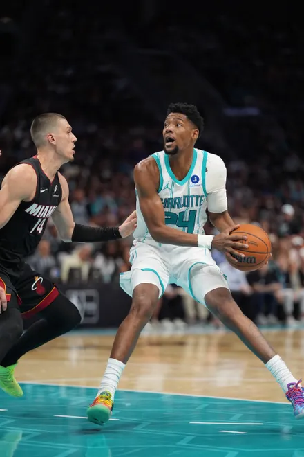 Apr 14, 2026; Charlotte, North Carolina, USA; Charlotte Hornets forward Brandon Miller (24) handles the ball against Miami Heat guard Tyler Herro (14) during the second half during the play-in rounds between the Charlotte Hornets and the Miami Heat of the 2026 NBA Playoffs at Spectrum Center. Mandatory Credit: Jim Dedmon-Imagn Images