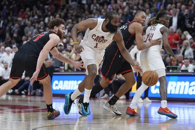 Apr 23, 2026; Toronto, Ontario, CAN; Cleveland Cavaliers guard James Harden (1) drives to the basket against Toronto Raptors forward Jamison Battle (77) and guard Scottie Barnes (4) during the second half of game three of the first round of the 2026 NBA Playoffs at Scotiabank Arena.