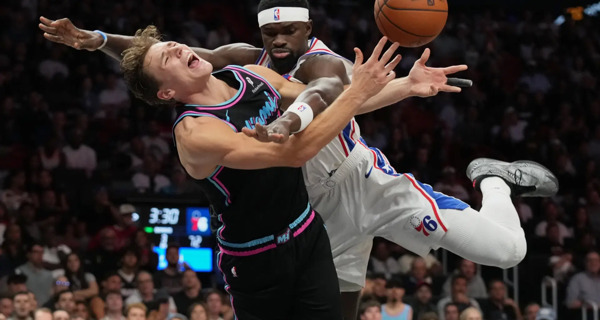 MIAMI — The agony of defeat, the agony of de-foul: Miami Heat guard Pelle Larsson, left, is fouled by Philadelphia 76ers center Adem Bona, right, during the second half of an NBA basketball game, Monday, March 30, 2026, in Miami. Photo: Lynne Sladky/AP