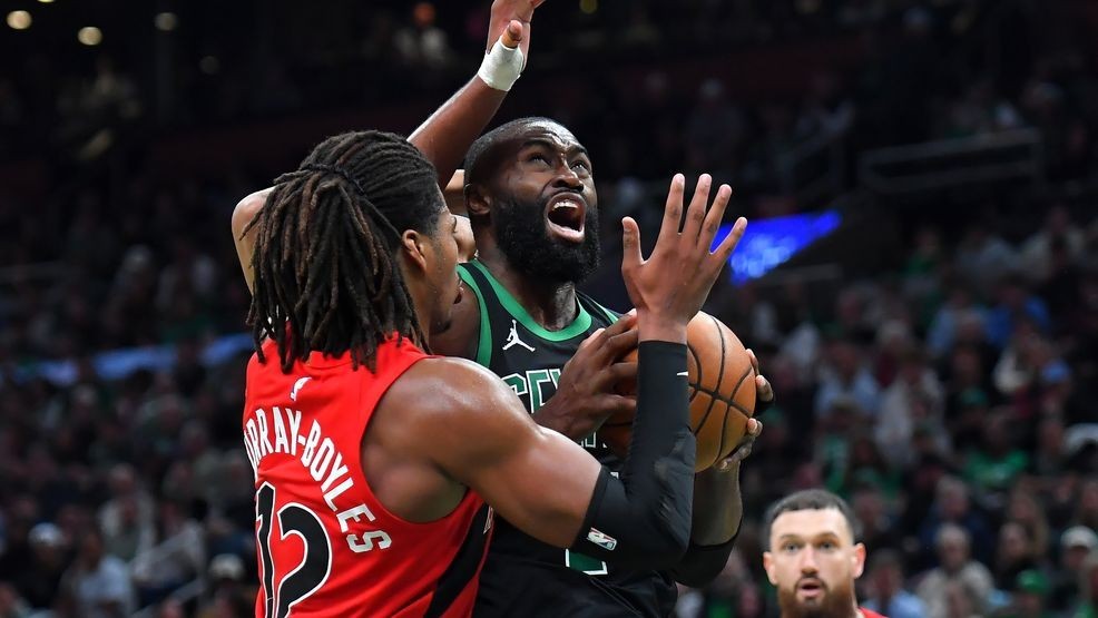 Boston Celtics guard Jaylen Brown drives toward the basket as Toronto Raptors forward Collin Murray-Boyles, left, defends in the second half of an NBA basketball game, Sunday, April 5, 2026, in Boston. (AP Photo/Steven Senne)