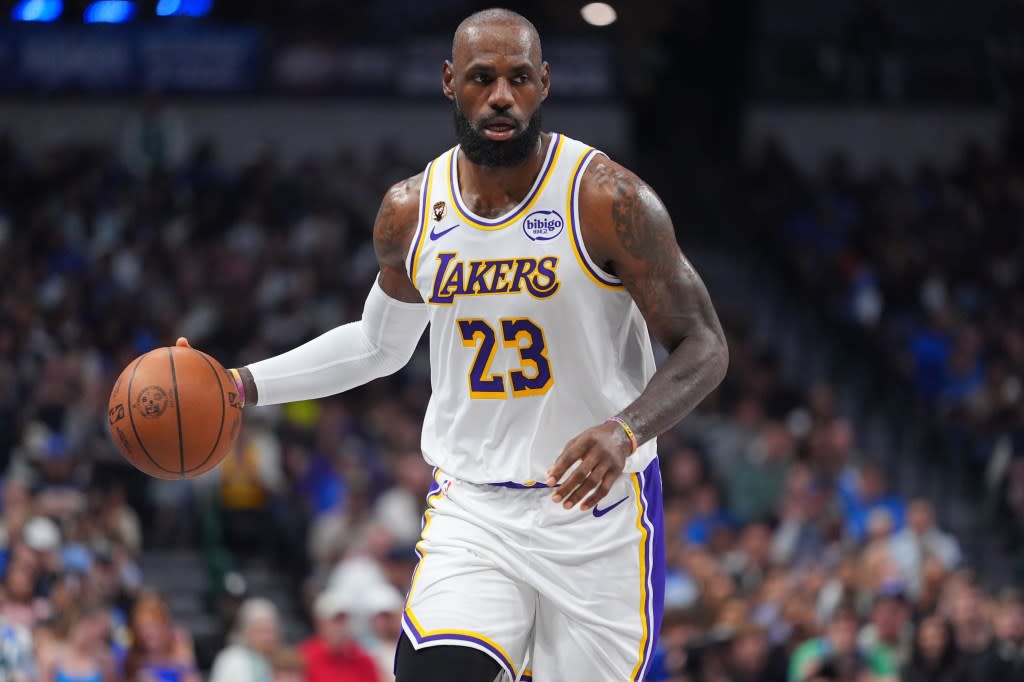 LeBron James brings the ball up against the Dallas Mavericks during the first half . AP