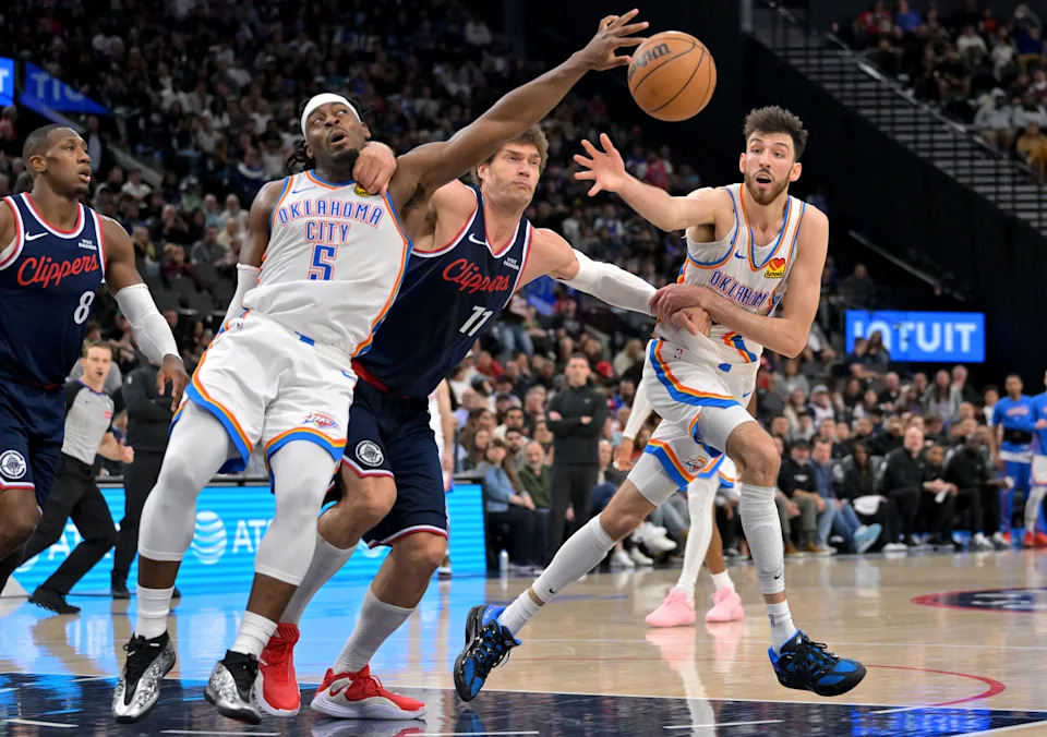Apr 8, 2026; Inglewood, California, USA; Oklahoma City Thunder guard Luguentz Dort (5), Los Angeles Clippers center Brook Lopez (11) and Oklahoma City Thunder center Chet Holmgren (7) battle for a loose ball in the second half at Intuit Dome. Mandatory Credit: Jayne Kamin-Oncea-Imagn Images
