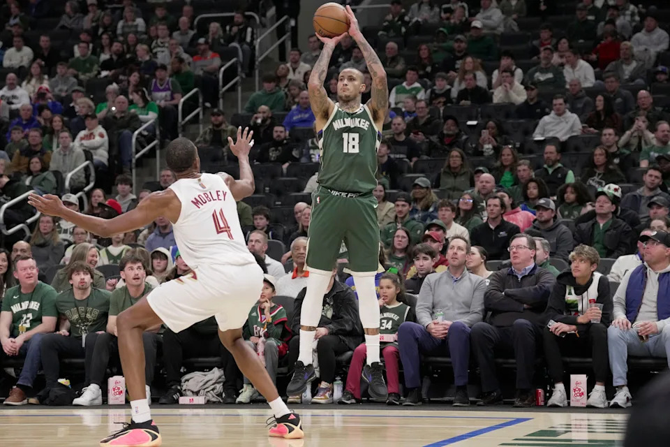 Milwaukee Bucks forward Kyle Kuzma (18) launches a three-point shot over Cleveland Cavaliers center Evan Mobley (4) during the first half of their game Tuesday, March 17, 2026 at Fiserv Forum in Milwaukee, Wisconsin.