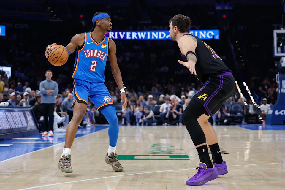 Apr 2, 2026; Oklahoma City, Oklahoma, USA; Oklahoma City Thunder guard Shai Gilgeous-Alexander (2) dribbles down the court as Los Angeles Lakers guard Luka Doncic (77) defends during the second half at Paycom Center. Mandatory Credit: Alonzo Adams-Imagn Images