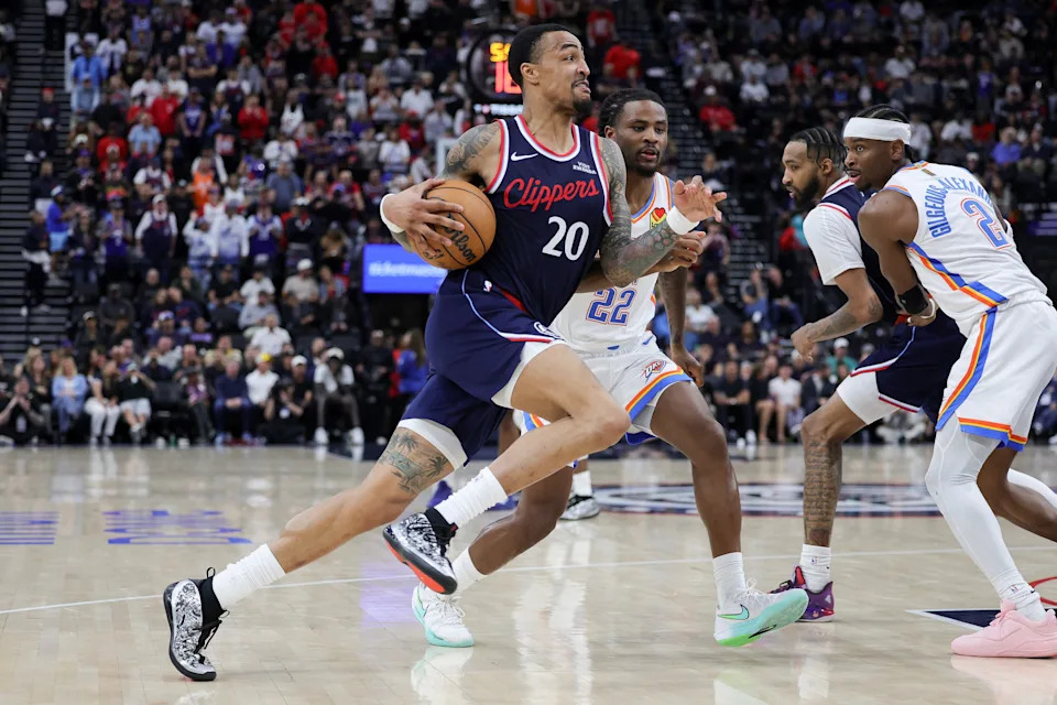 INGLEWOOD, CALIFORNIA - APRIL 08: John Collins #20 of the Los Angeles Clippers drives against Cason Wallace #22 of the Oklahoma City Thunder during the first half of an NBA game at Intuit Dome on April 08, 2026 in Inglewood, California. NOTE TO USER: User expressly acknowledges and agrees that, by downloading and or using this photograph, User is consenting to the terms and conditions of the Getty Images License Agreement. (Photo by Ryan Sirius Sun/Getty Images)