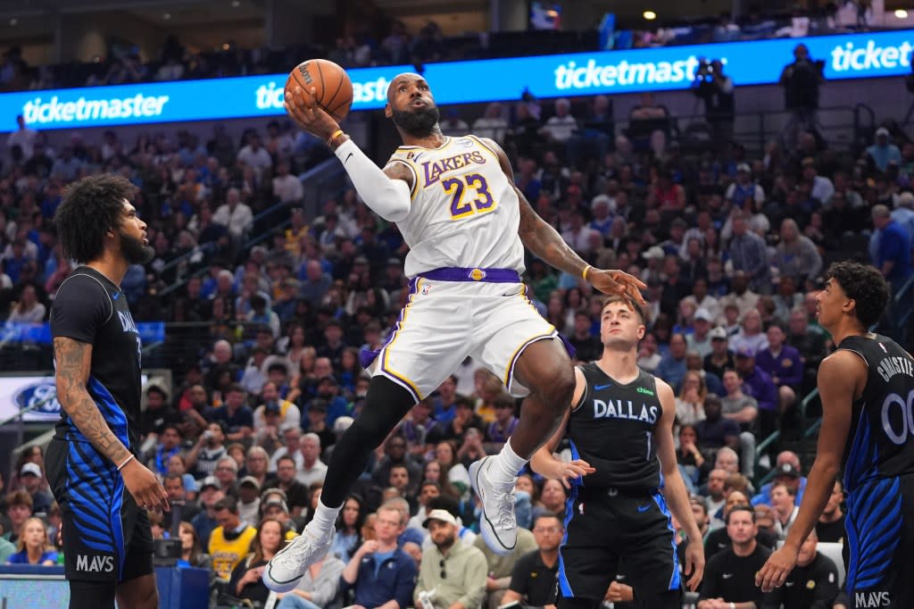 LeBron James drives against the Mavericks during the first half. AP