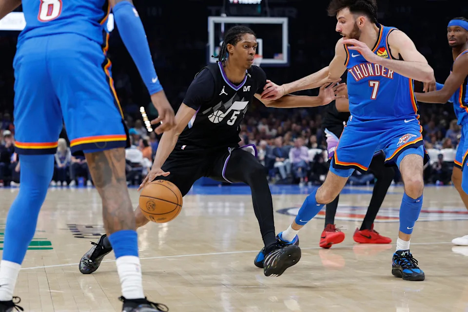 Apr 5, 2026; Oklahoma City, Oklahoma, USA; Utah Jazz forward Cody Williams (5) drives between Oklahoma City Thunder guard Jalen Williams (8) and center Chet Holmgren (7) during the second half at Paycom Center. Mandatory Credit: Alonzo Adams-Imagn Images
