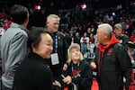 Portland Trail Blazers new owner Tom Dundon stands with his son and Andrew Cherng, Portland Trail Blazers alternate governor, right, after an NBA basketball game against the New Orleans Pelicans, Thursday, April 2, 2026, in Portland, Ore.
