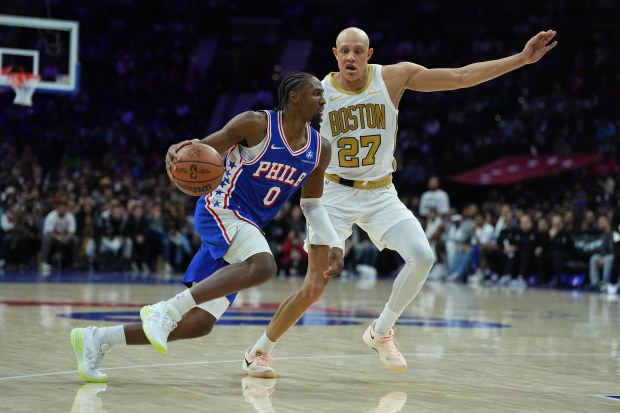 Philadelphia 76ers' Tyrese Maxey tries to get past Boston Celtics' Jordan Walsh during the second half of an NBA basketball game Tuesday, Nov. 11, 2025, in Philadelphia. (AP Photo/Matt Rourke)