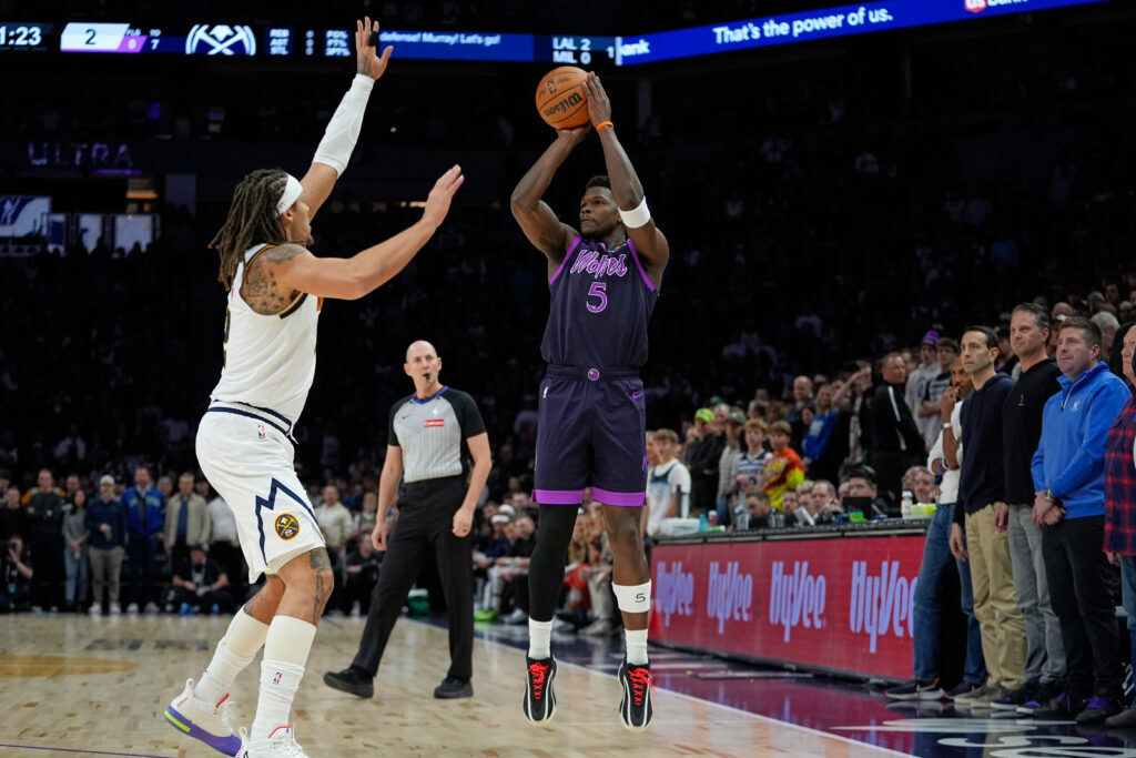 Minnesota Timberwolves guard Anthony Edwards (5) shoots over Denver Nuggets forward Aaron Gordon (32) during the first half of an NBA basketball game, Saturday, Nov. 15, 2025, in Minneapolis. (AP Photo/Abbie Parr)
