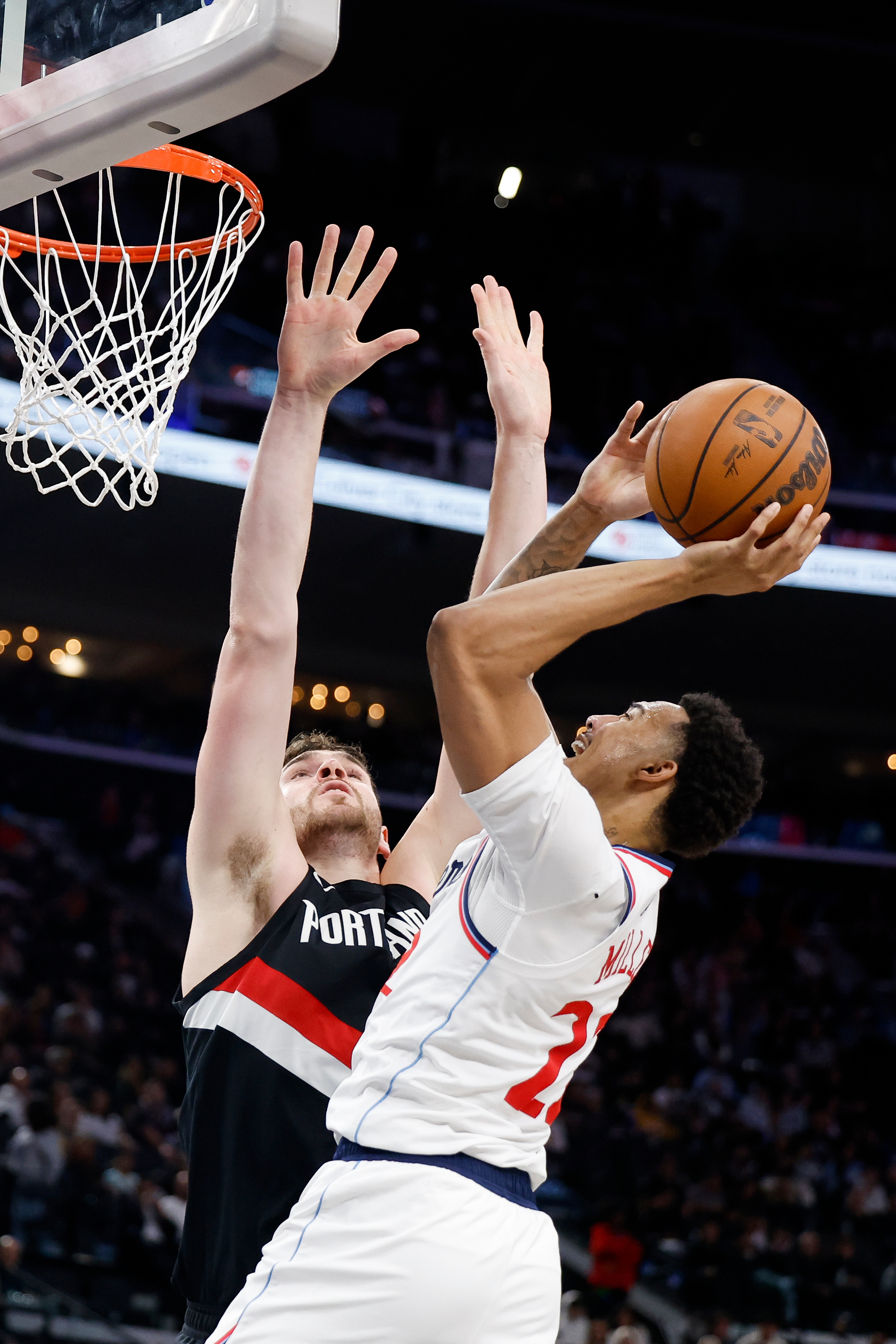 Clippers guard Jordan Miller, right, drives to the basket with...