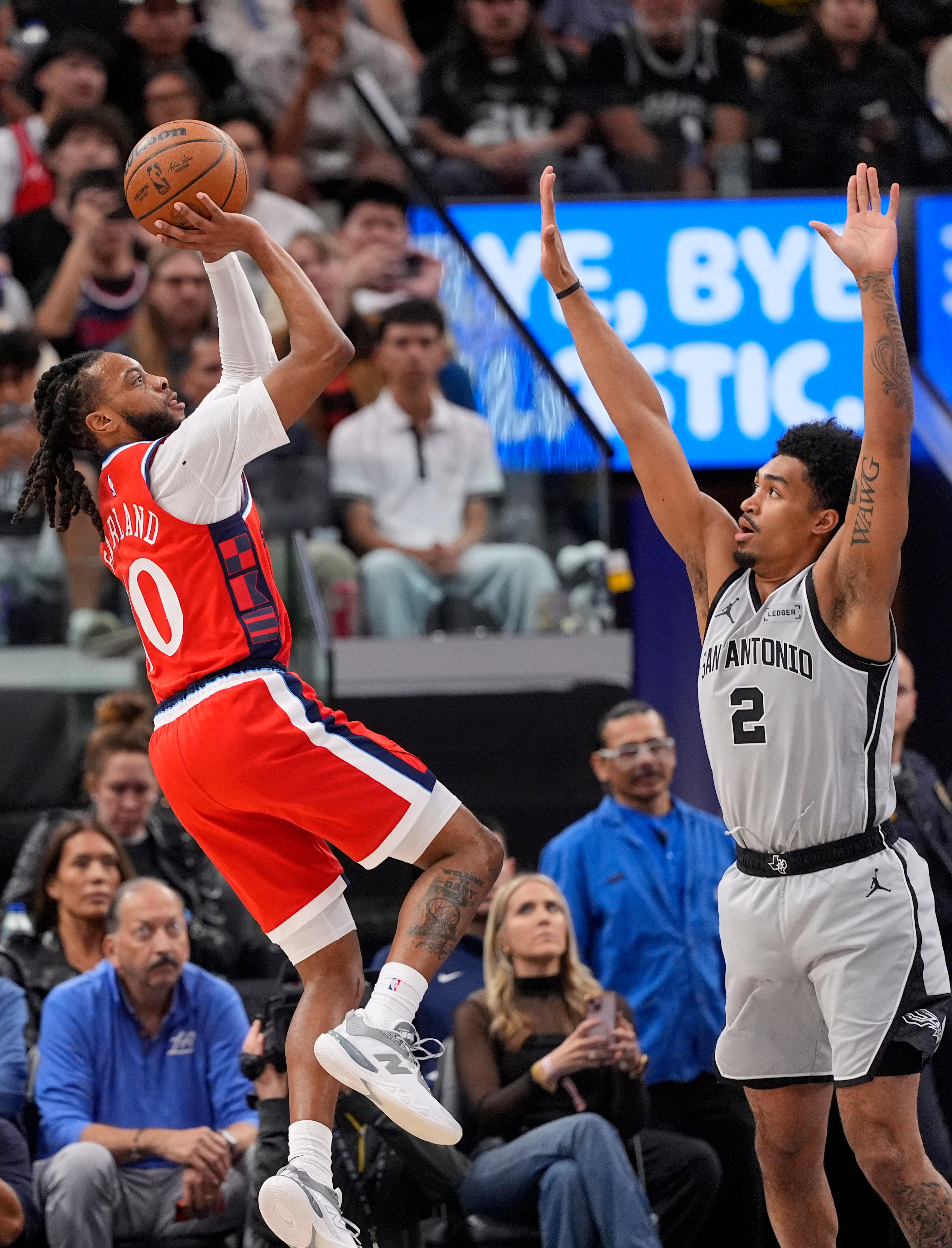 Clippers point guard Darius Garland, left, shoots as San Antonio...