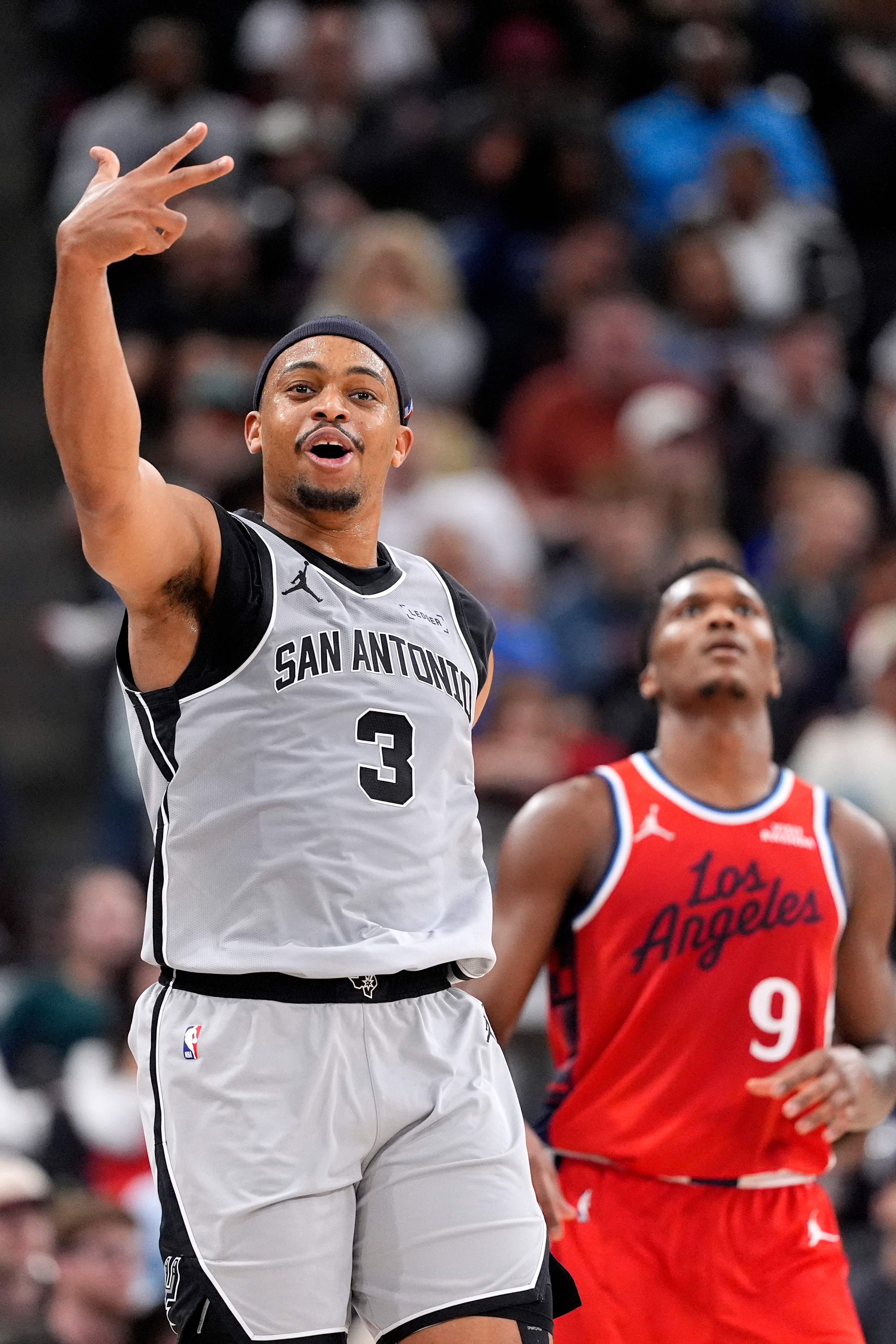 San Antonio Spurs forward Keldon Johnson, left, celebrates after scoring...