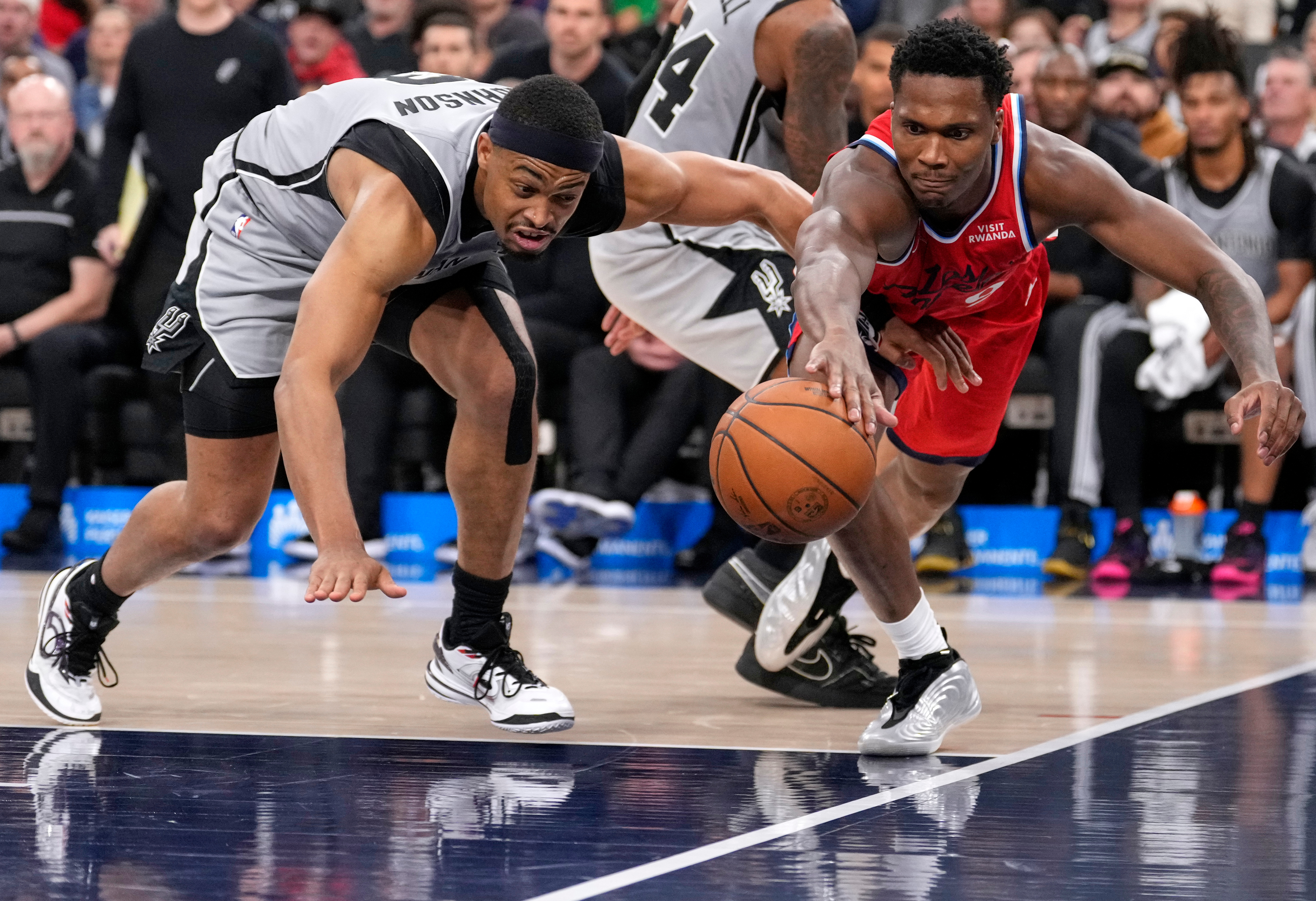 San Antonio Spurs forward Keldon Johnson, left, and Clippers guard...