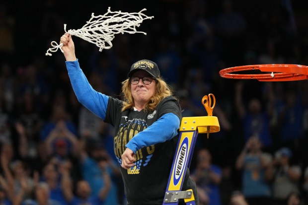 UCLA head coach Cori Close celebrates with the net after UCLA defeated South Carolina in the women's National Championship Final Four NCAA college basketball tournament game, Sunday, April 5, 2026, in Phoenix. (AP Photo/Rick Scuteri)
