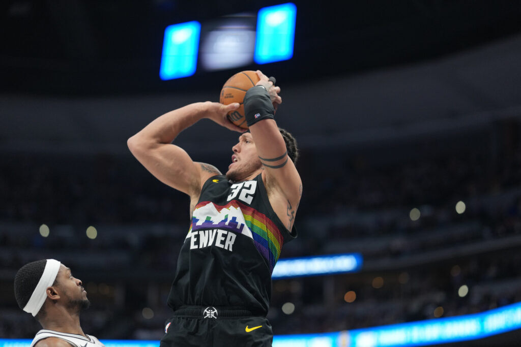 Denver Nuggets forward Aaron Gordon (32) shoots over San Antonio Spurs guard De'aaron Fox (4) in the second half of an NBA basketball game Saturday, April 4, 2026, in Denver. (AP Photo/David Zalubowski)