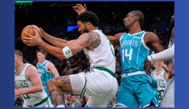 Boston Celtics forward Jayson Tatum, left, grabs a rebound against Charlotte Hornets forward Moussa Diabate (14) during the first half of a NBA basketball game, Tuesday, April 7, 2026, in Boston. (AP Photo/Charles Krupa)