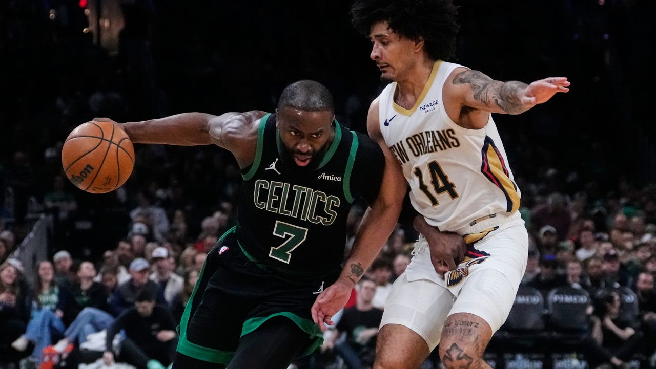 Boston Celtics guard Jaylen Brown (7) drives to the basket against New Orleans Pelicans guard Micah Peavy (14) during the second half of an NBA basketball game, Friday, April 10, 2026, in Boston. (AP Photo/Charles Krupa)