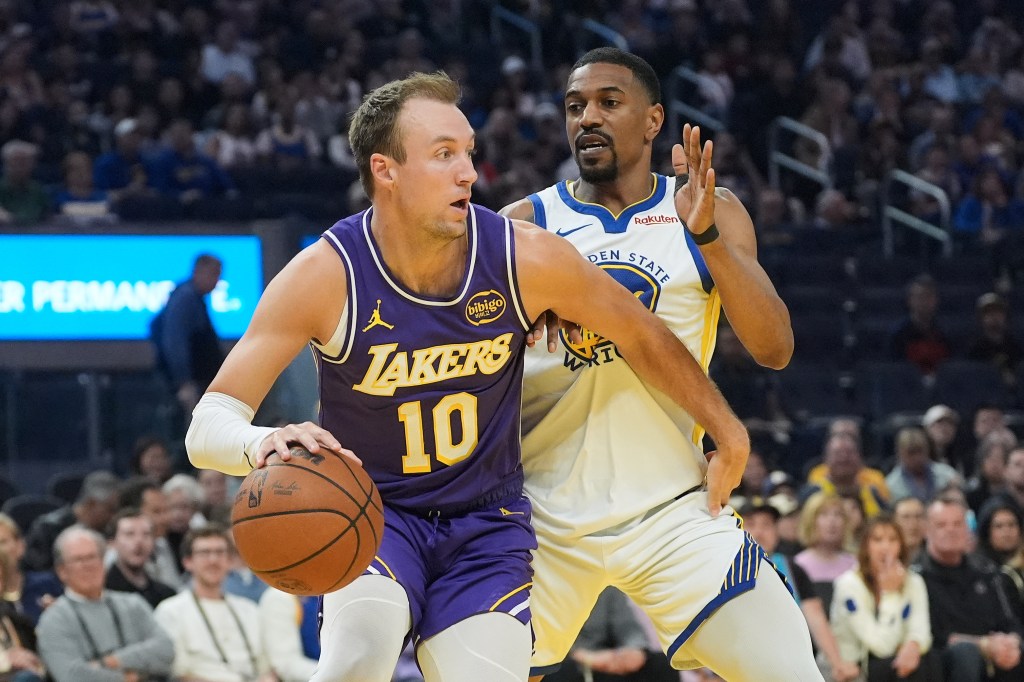 Los Angeles Lakers guard Luke Kennard drives to the basket against Golden State Warriors guard De'Anthony Melton.