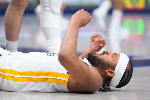 Golden State Warriors guard Moses Moody reacts after being fouled by Dallas Mavericks forward Cooper Flagg during overtime of an NBA basketball game Monday, March 23, 2026, in Dallas. (AP Photo/Julio Cortez)