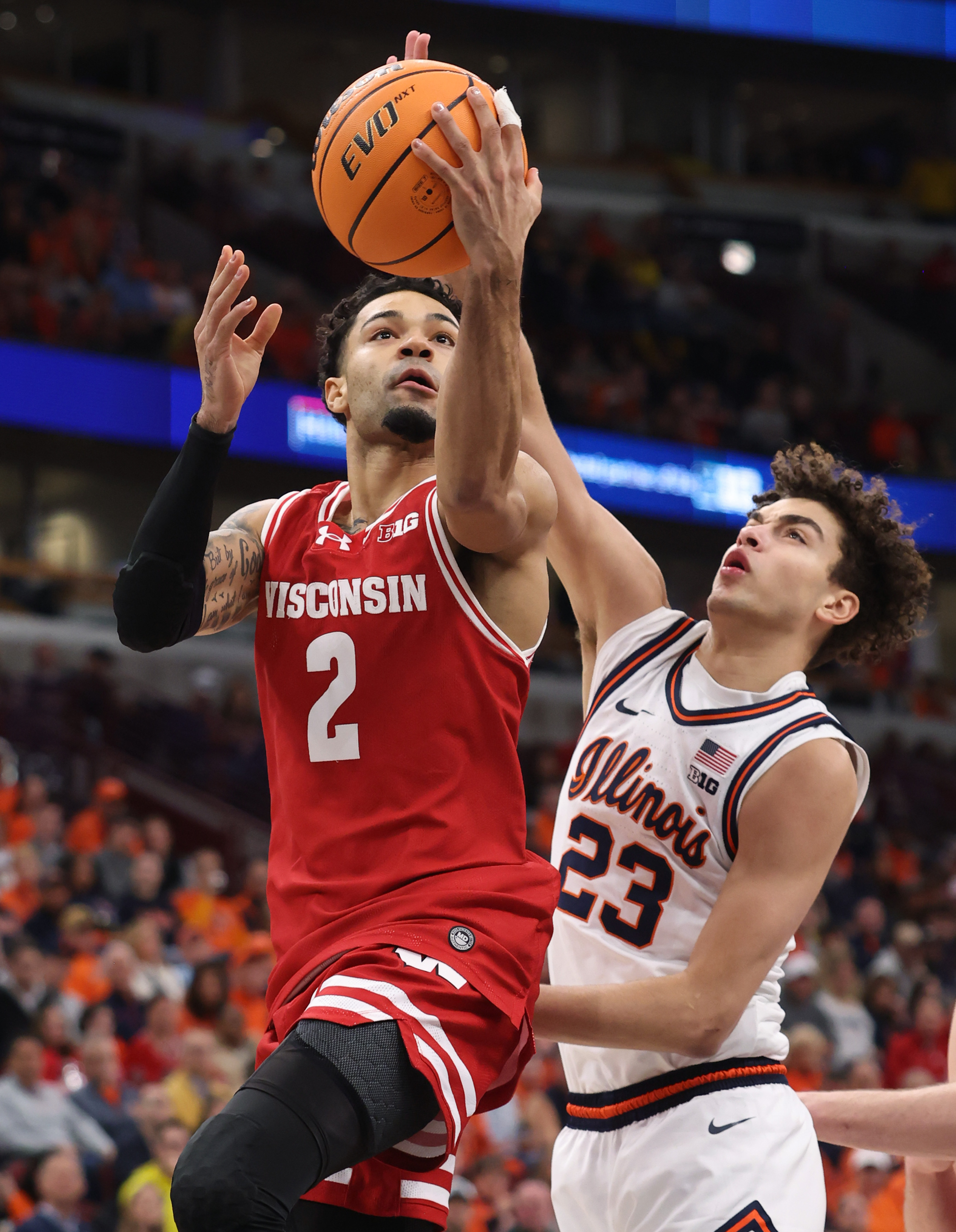 Wisconsin guard Nick Boyd (2) aims for the net as...