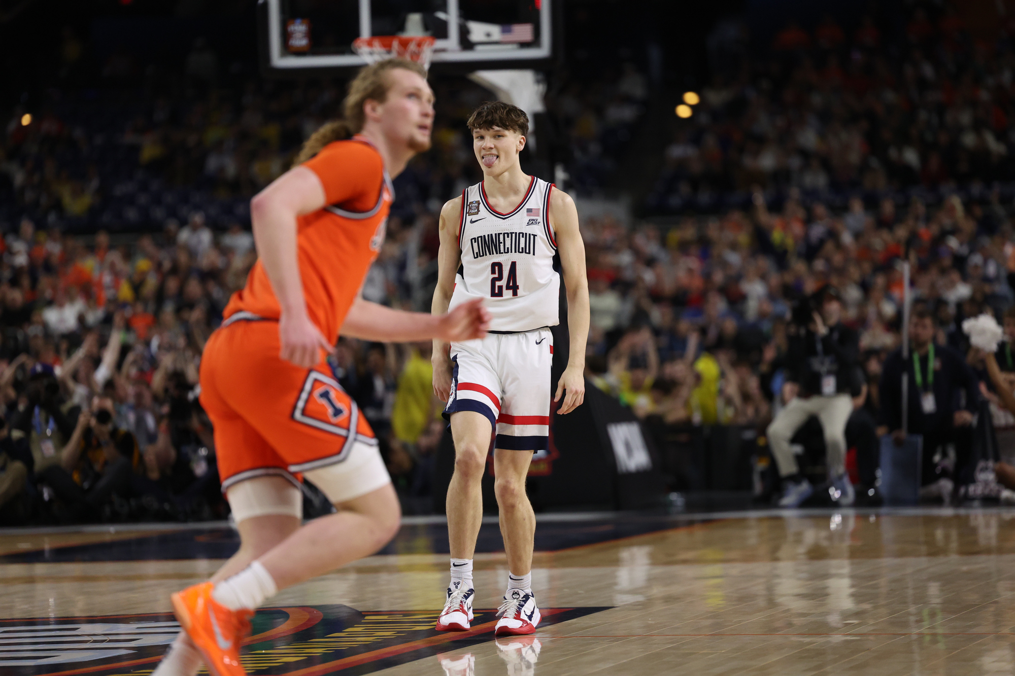 UConn guard Braylon Mullins (24) reacts after hitting a first-half...