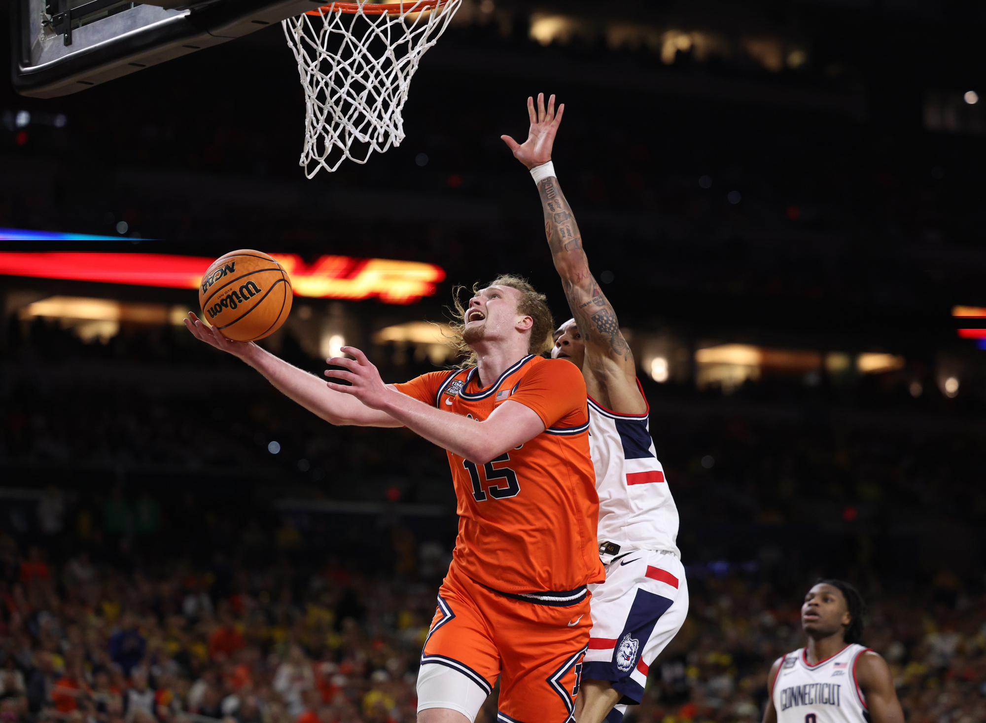 Illinois forward Jake Davis (15) is fouled by UConn guard...