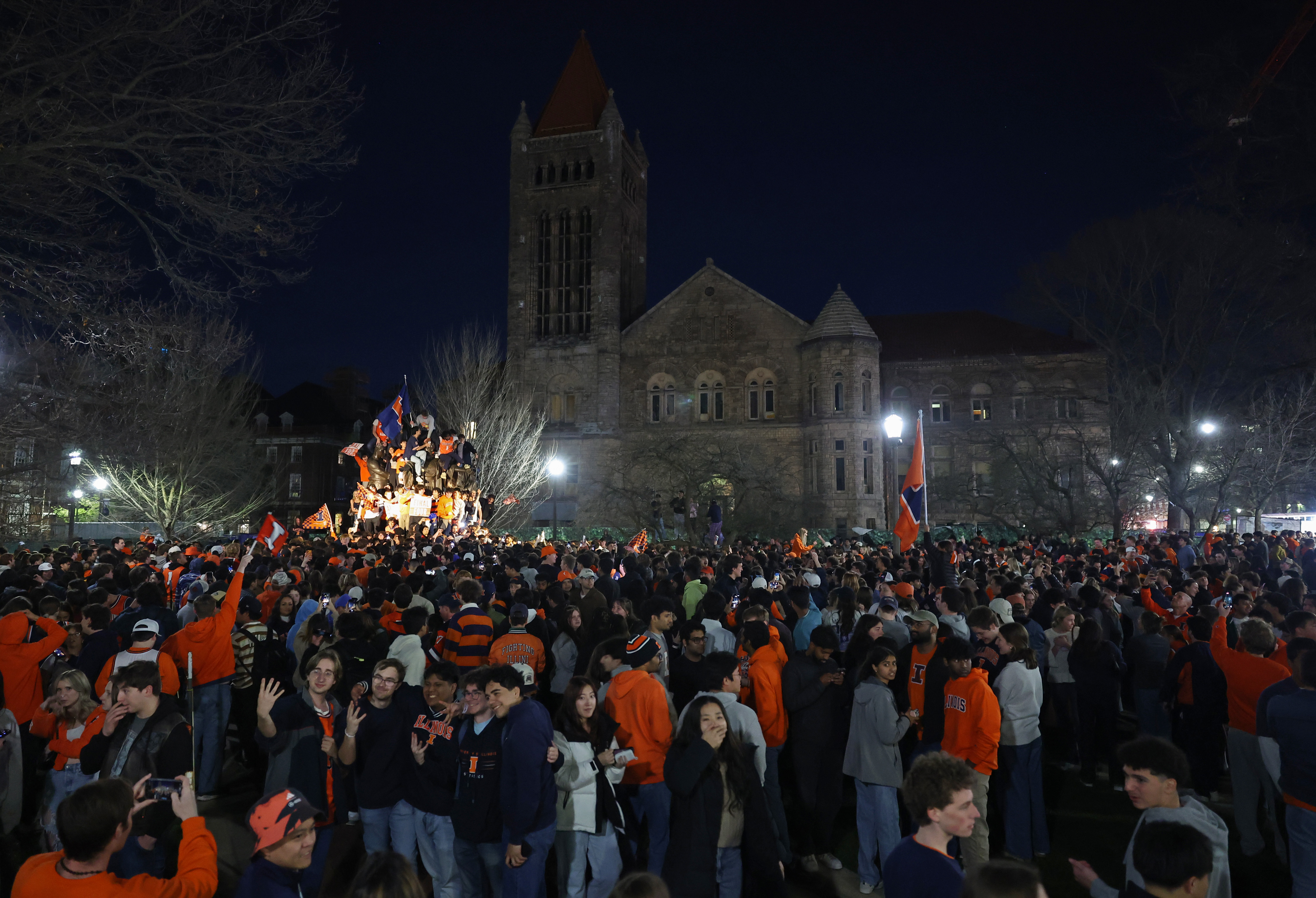 Student fans and others celebrate at the University of Illinois...