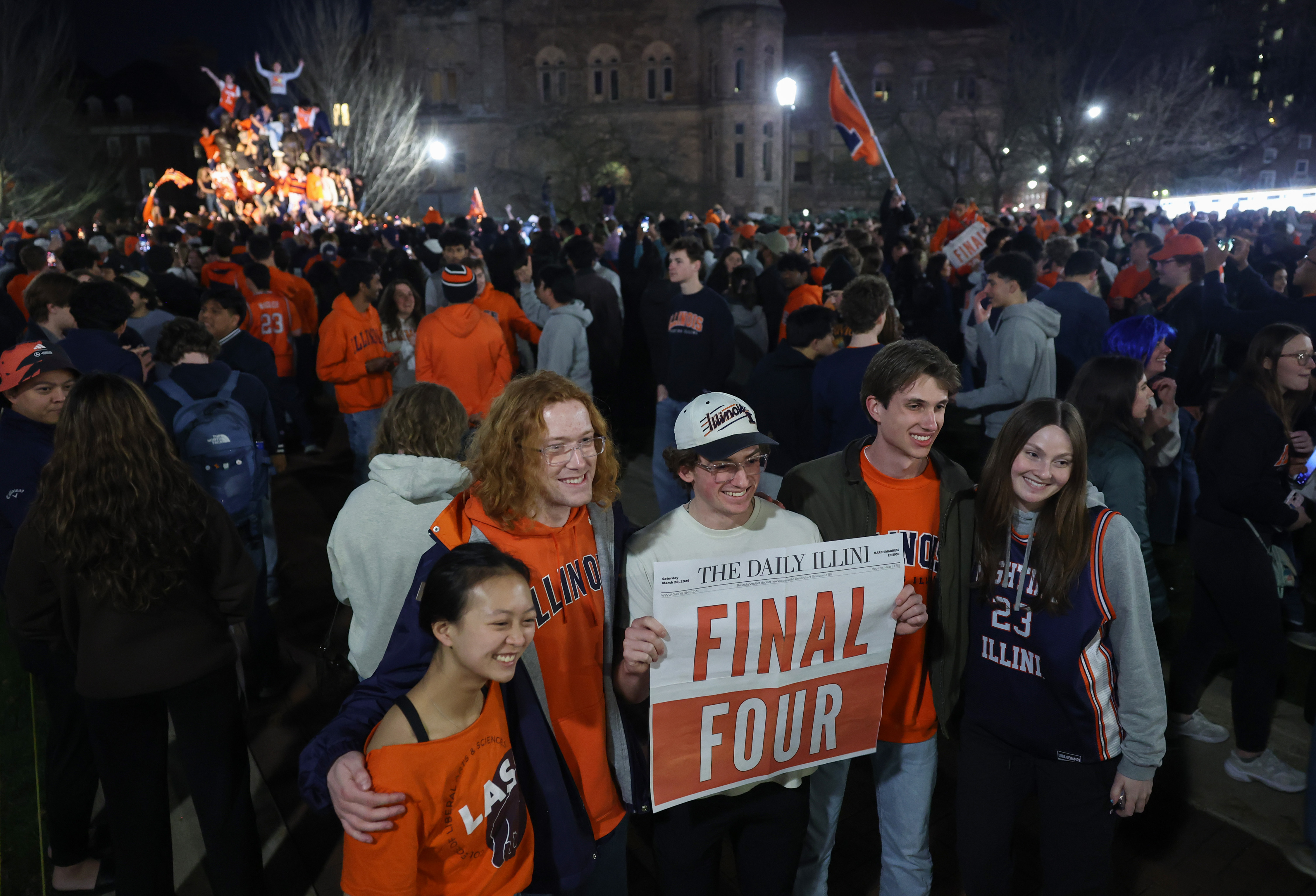 Student fans and others celebrate at the University of Illinois...