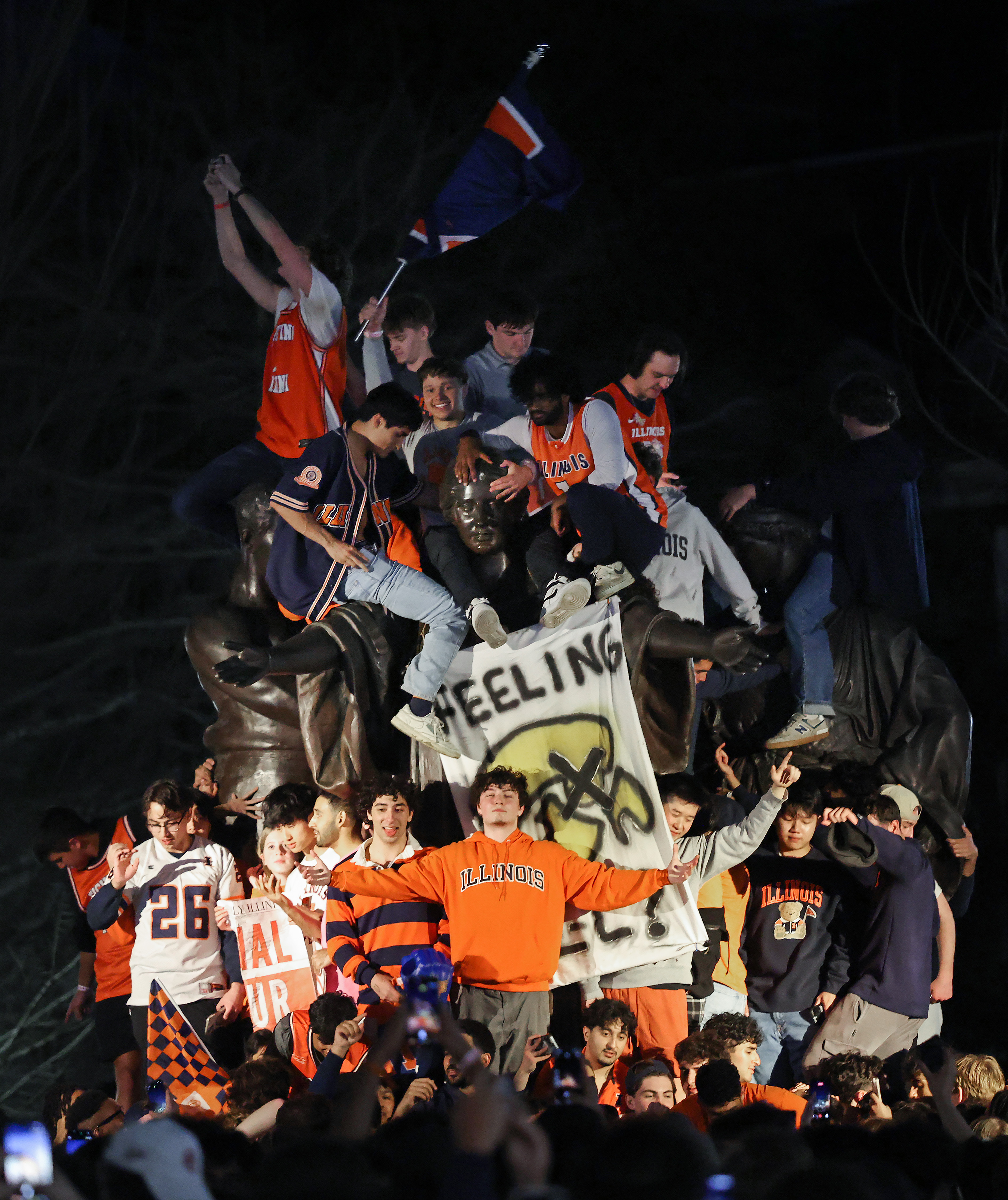Student fans and others celebrate at the University of Illinois...