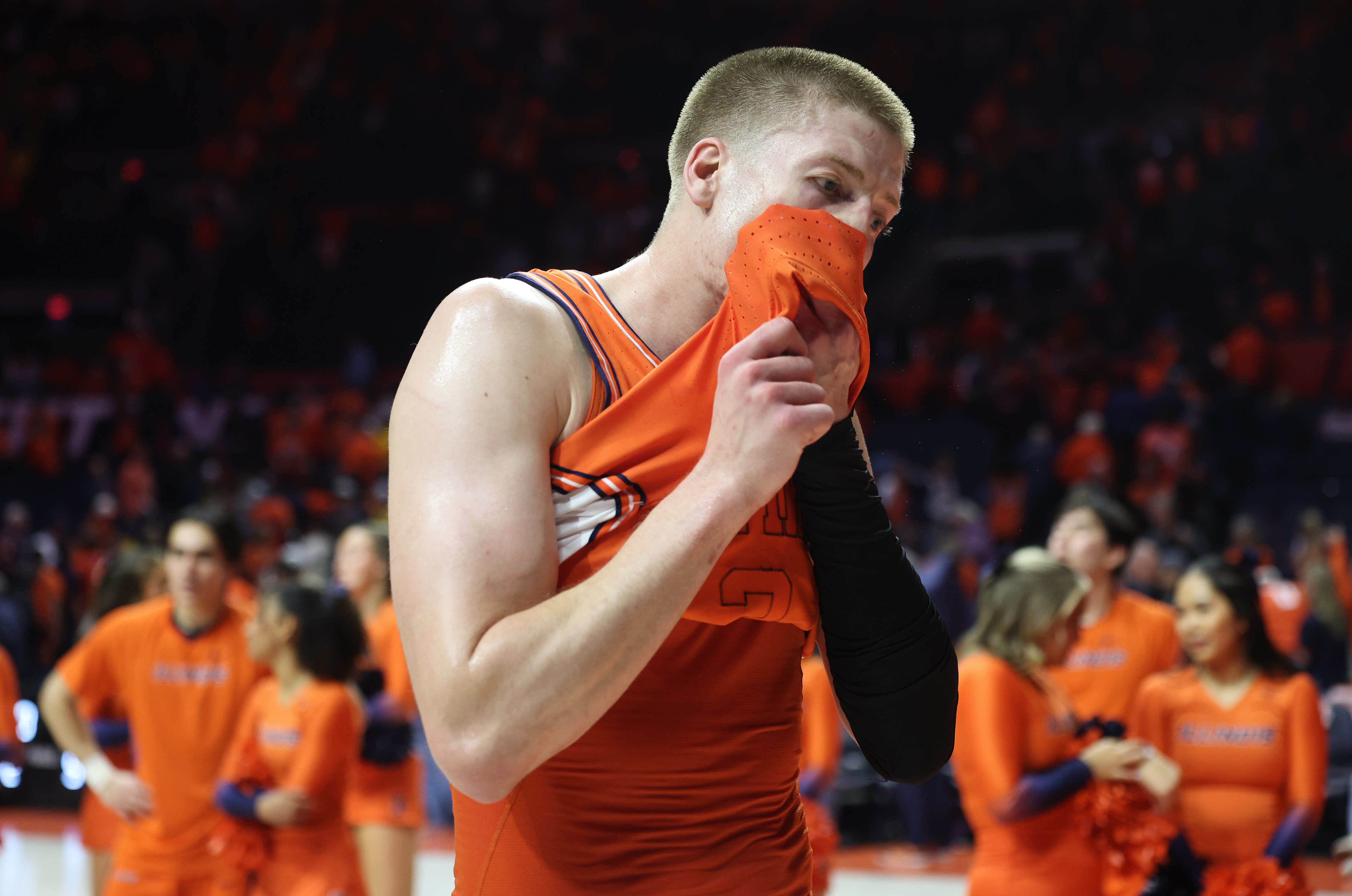 Illinois forward Ben Humrichous wipes off sweat as he walks...