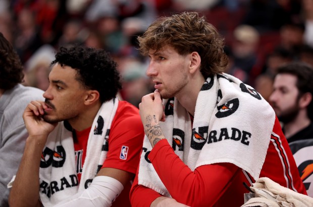 Chicago Bulls guard Tre Jones (left) and forward Matas Buzelis (14) look on from the bench in the second half of a game against the Indiana Pacers at the United Center in Chicago on April 1, 2026. (Chris Sweda/Chicago Tribune)