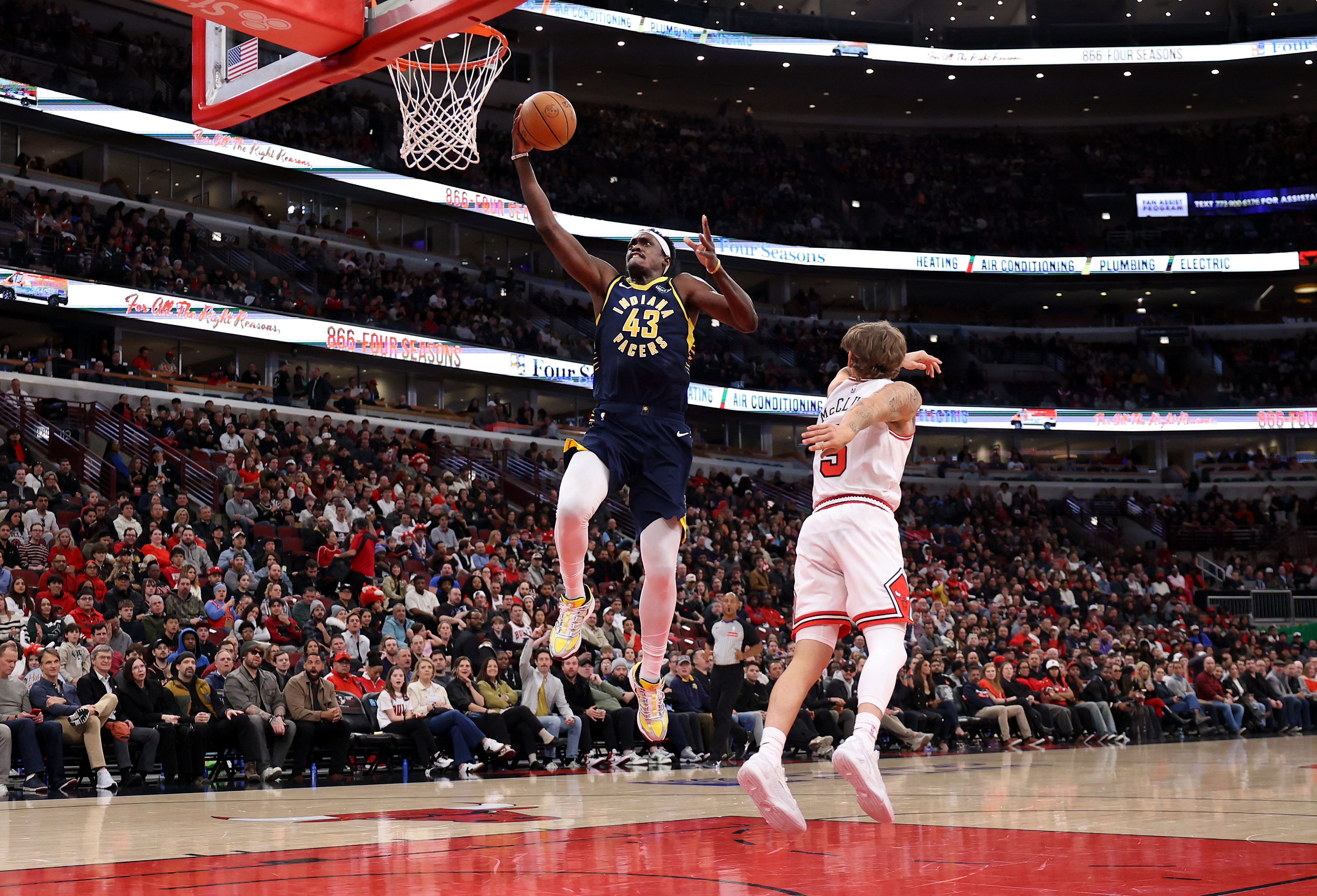 Indiana Pacers forward Pascal Siakam (43) drives past Chicago Bulls guard Mac McClung (5) before dunking the ball in the first half of a game at the United Center in Chicago on April 1, 2026. (Chris Sweda/Chicago Tribune)