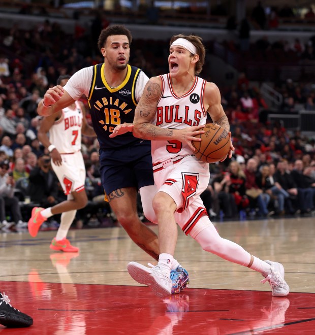 Chicago Bulls guard Mac McClung (5) drives on Indiana Pacers forward Jalen Slawson (18) in the second half of a game at the United Center in Chicago on April 1, 2026. (Chris Sweda/Chicago Tribune)