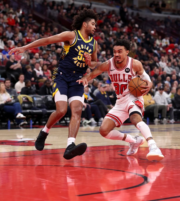 Chicago Bulls guard Tre Jones (30) puts a move on Indiana Pacers guard Ethan Thompson (55) in the second half of a game at the United Center in Chicago on April 1, 2026. (Chris Sweda/Chicago Tribune)