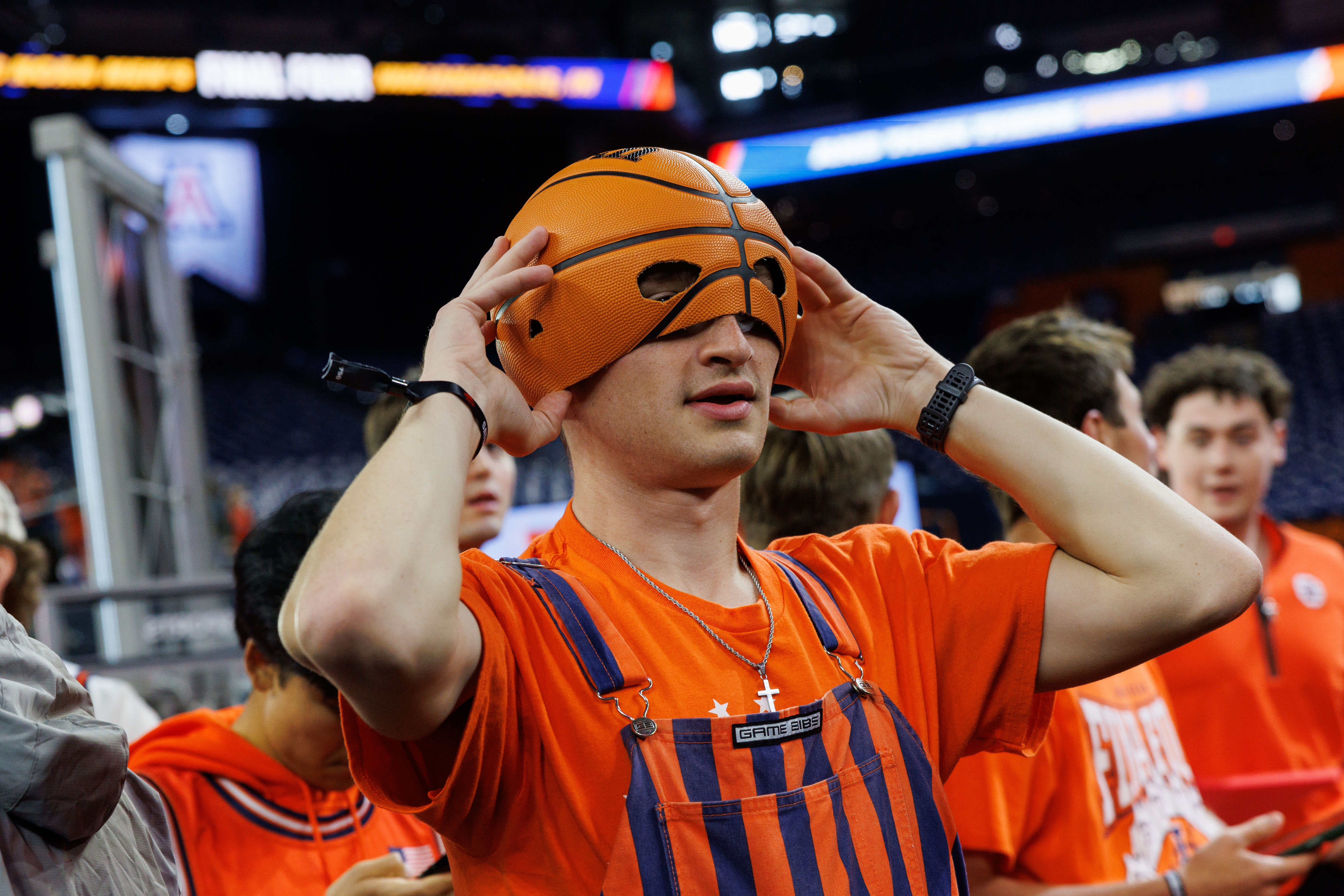 Hudson Coady, 20, puts on a basketball hat before the...