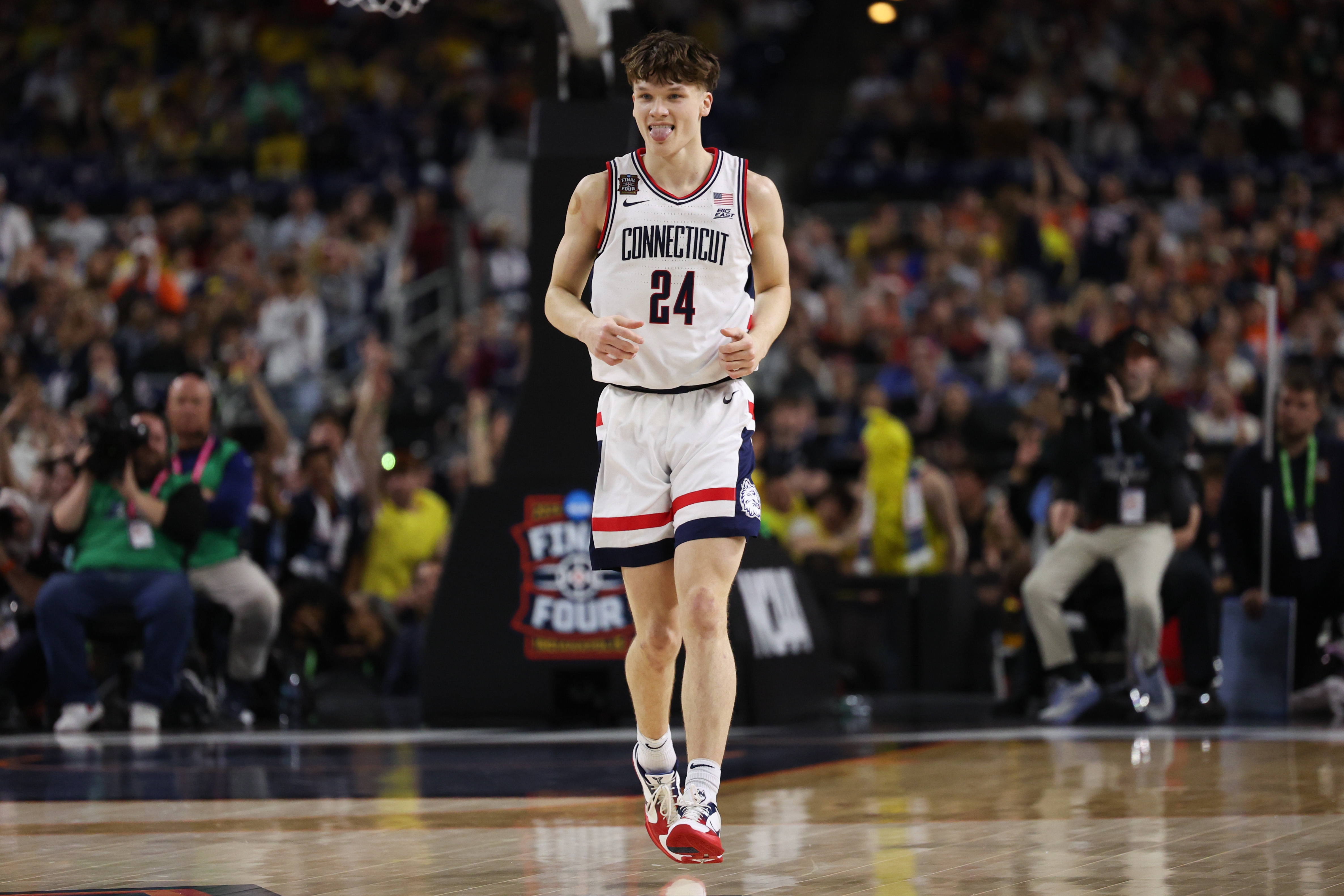 UConn guard Braylon Mullins sticks out his tongue after making...