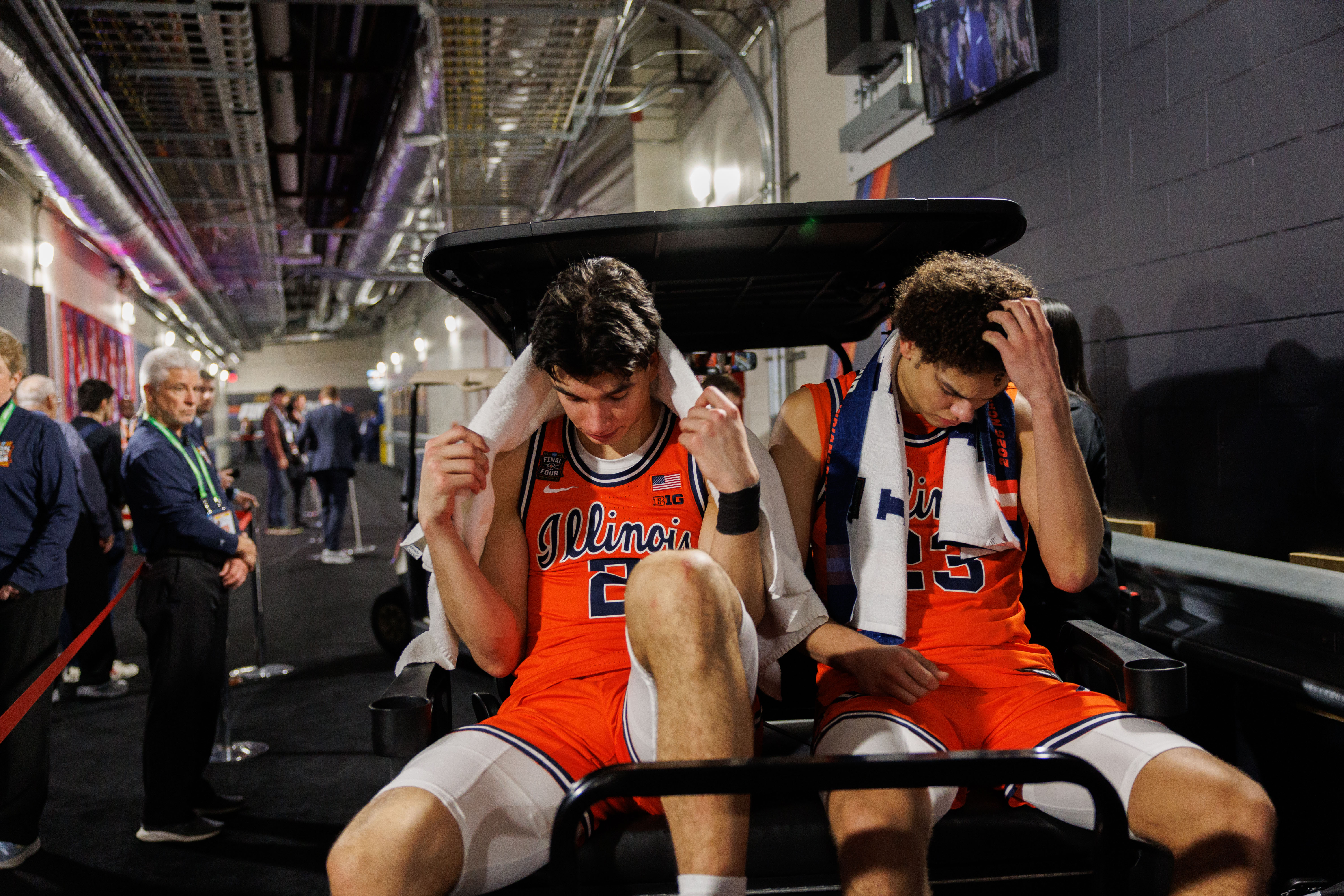 Andrej StojakoviÄ, left, and Keaton Wagler ride a cart to...