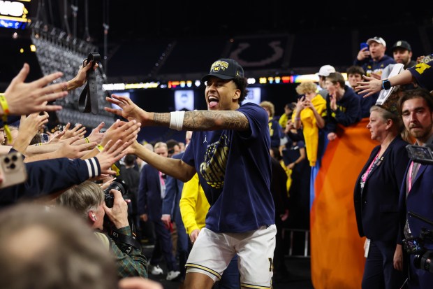 Michigan forward Yaxel Lendeborg (23) celebrates with fans after defeating UConn, 69-63, in the NCAA title game on April 6, 2026, at Lucas Oil Stadium in Indianapolis. (Armando L. Sanchez/Chicago Tribune)