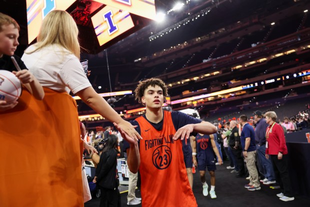 Illinois Fighting Illini guard Keaton Wagler (23) high-fives fans after practice before the Saturday Final Four semifinal match against UConn April 3, 2026, at Lucas Oil Stadium in Indianapolis. (Armando L. Sanchez/Chicago Tribune)