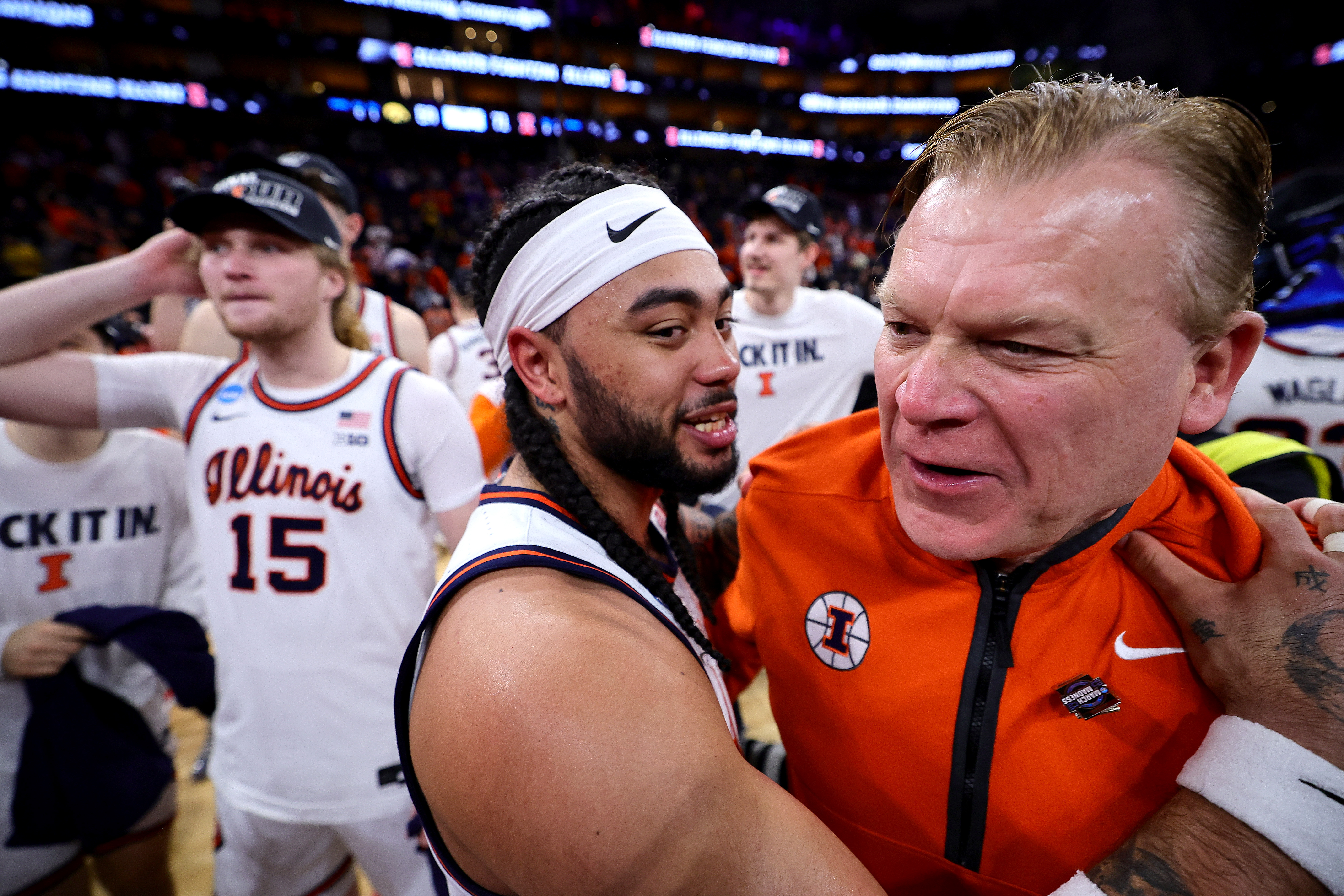 Illinois coach Brad Underwood and Kylan Boswell celebrate after defeating...