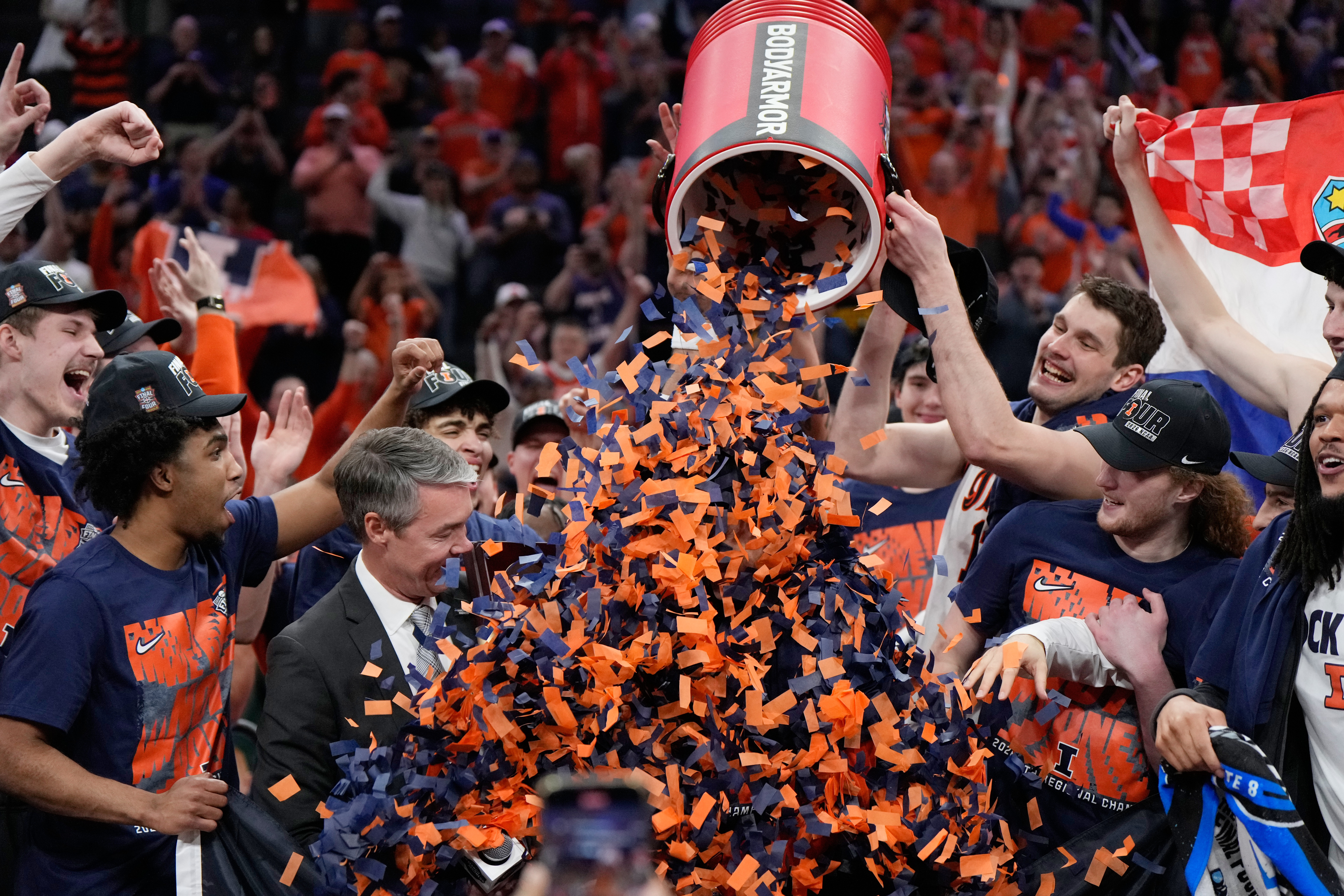 Illinois players pour confetti on coach Brad Underwood after the...
