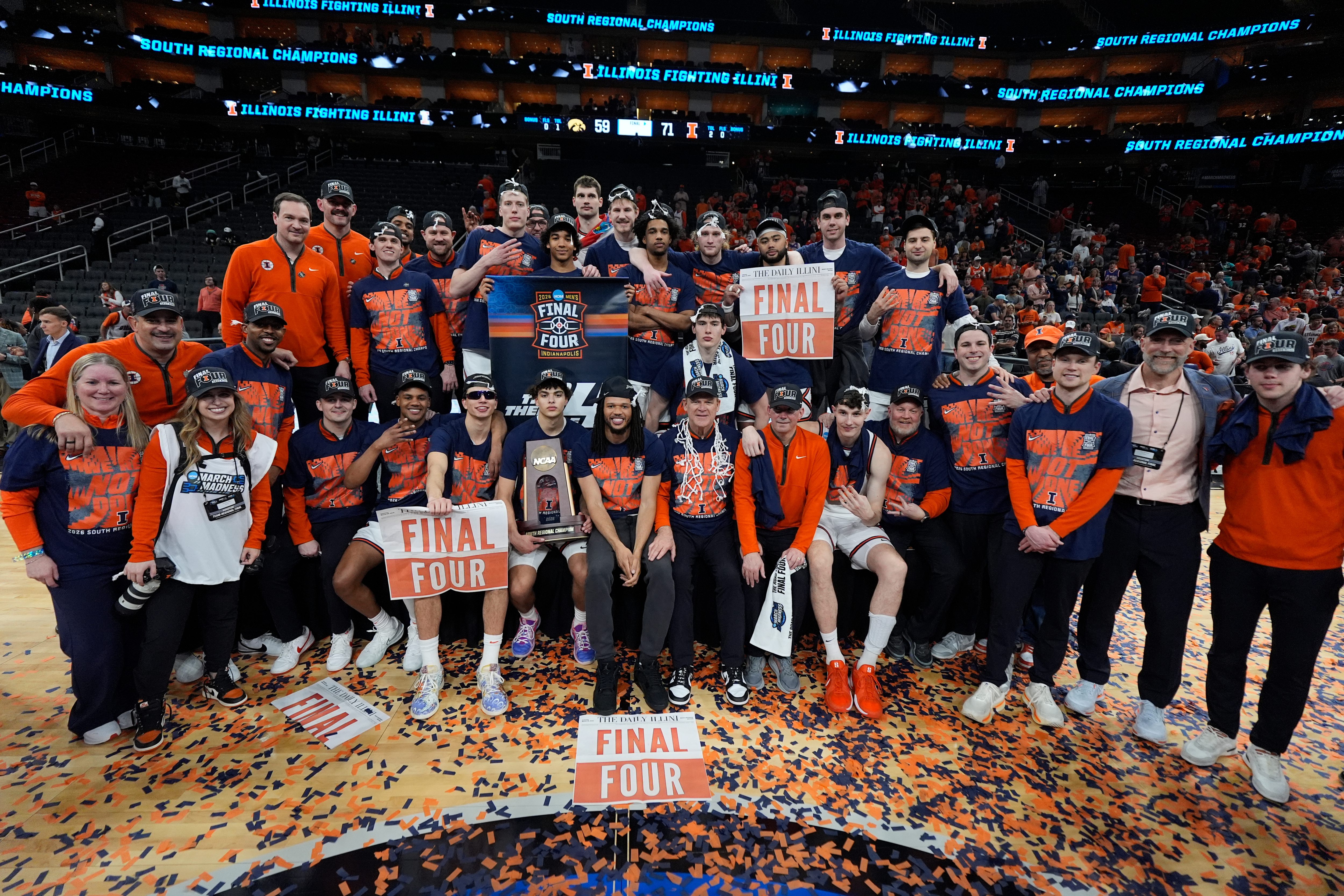 The Illinois basketball team celebrates after beating Iowa in the...