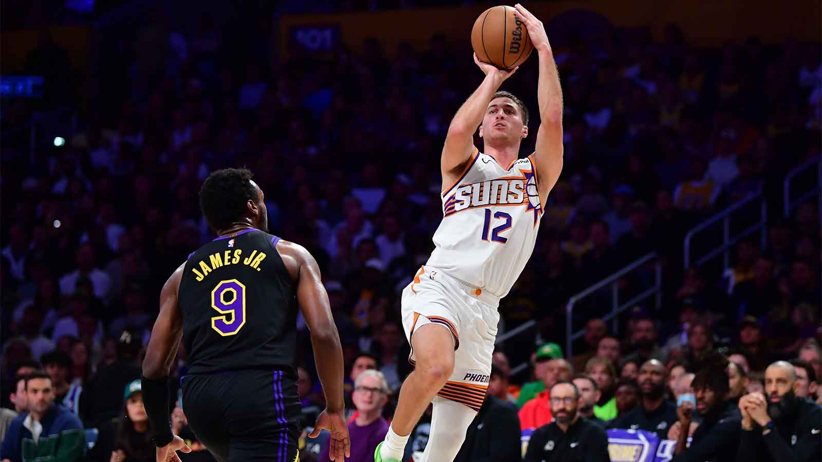 Phoenix Suns guard Collin Gillespie (12) shoots against Los Angeles Lakers guard Bronny James (9) during the first half at Crypto.com Arena. 