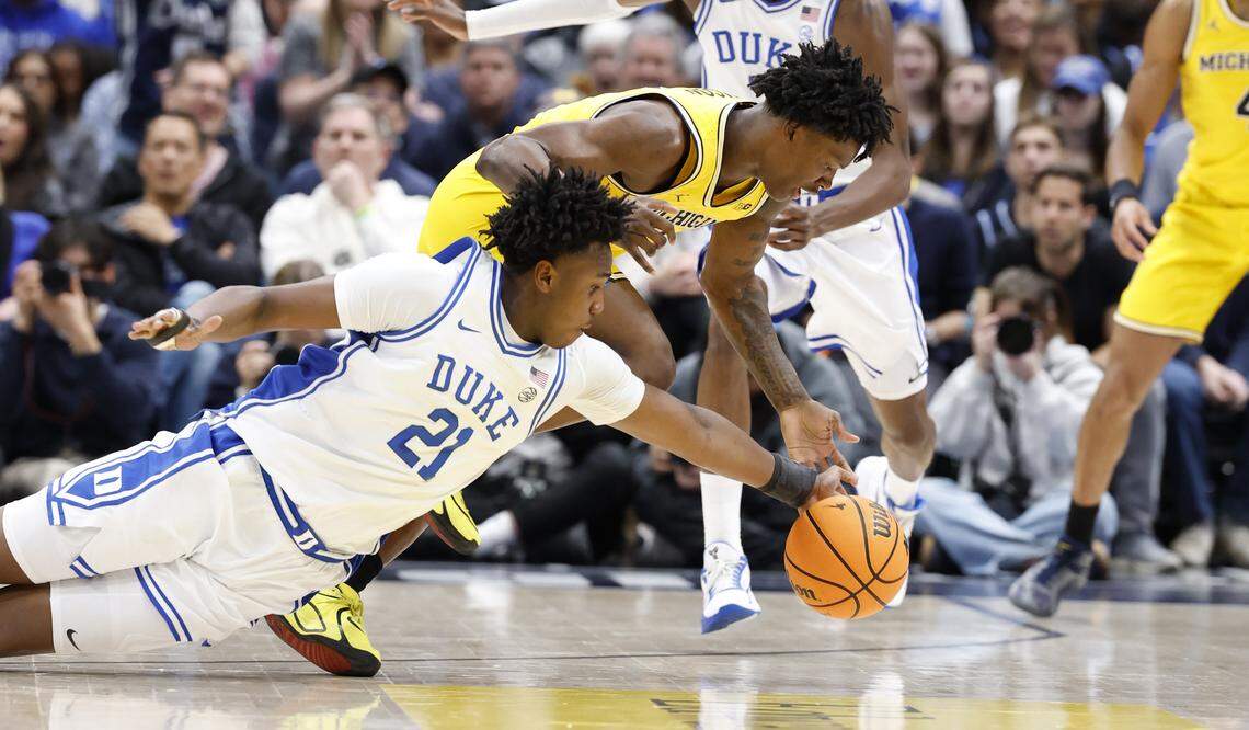 Duke’s Patrick Ngongba II (21) gets to the loose ball before Michigan's L.J. Cason (2) during the first half of Duke’s game against Michigan in the Capital Showcase at Capital One Arena in Washington, D.C., Saturday, Feb. 21, 2026.