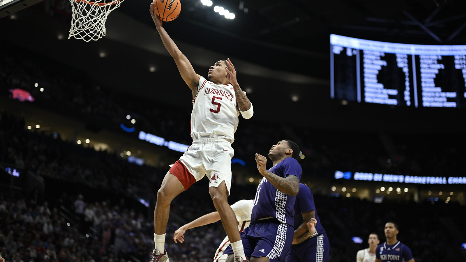  Arkansas Razorbacks guard Darius Acuff Jr. (5) shoots against High Point Panthers forward Cam'ron Fletcher (11) in the second half during a second round game of the men's 2026 NCAA Tournament at Moda Center.