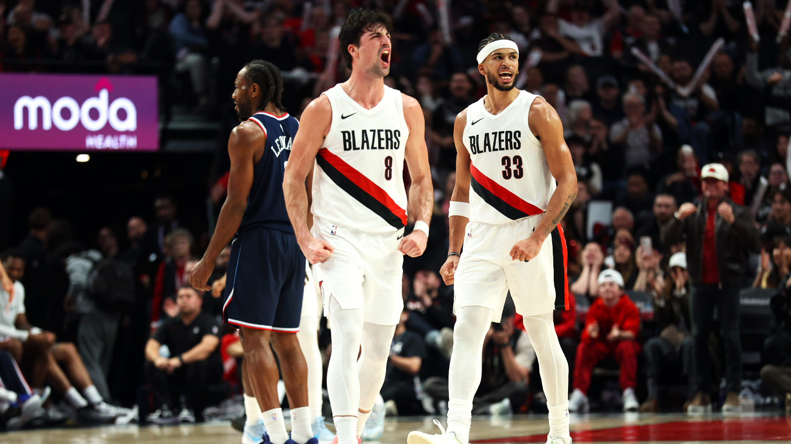 Portland Trail Blazers forward Deni Avdija (8) and forward Toumani Camara (33) react after a play against the LA Clippers during the second half at Moda Center.
