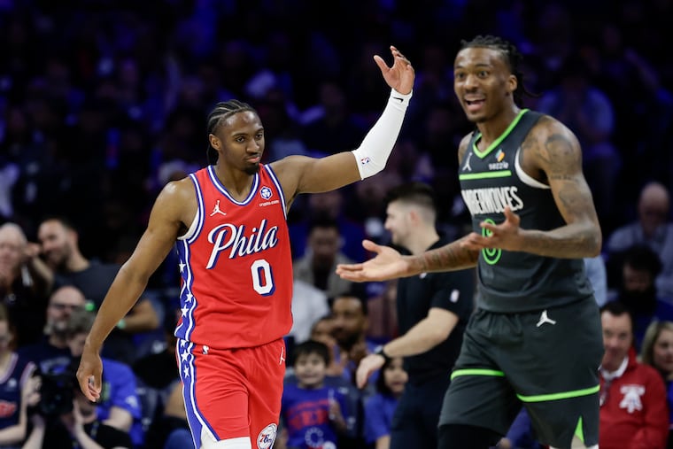 Sixers guard Tyrese Maxey waves to the Sixers crowd past Minnesota Timberwolves guard Bones Hyland at the end of the third quarter on Friday, April 3, 2026 in Philadelphia.