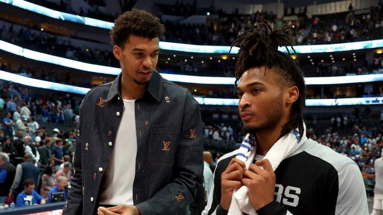 San Antonio Spurs center Victor Wembanyama confers with guard Stephon Castle
